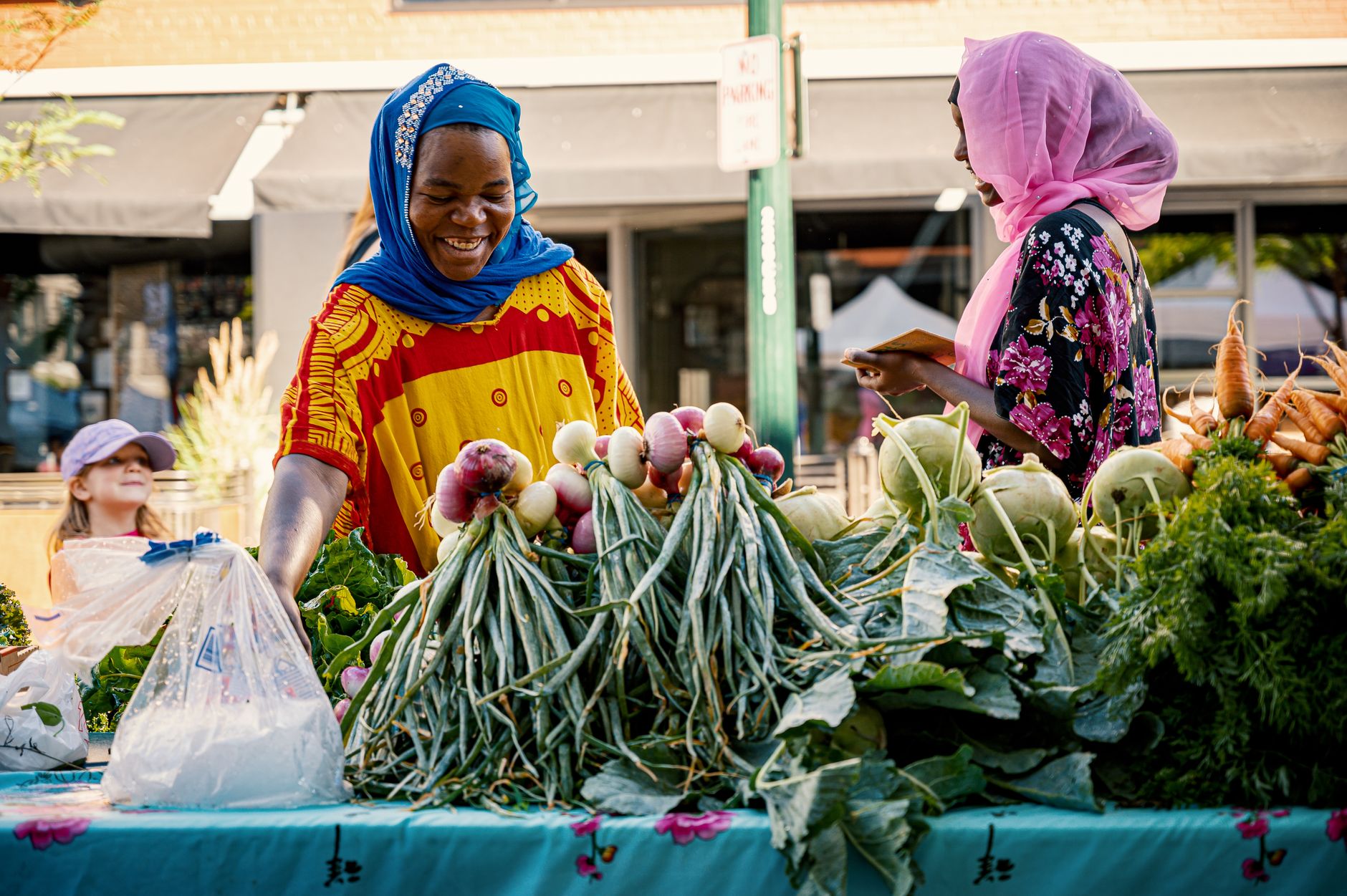 Members and a vendor trading fresh produce at a community farmers-market cooperative